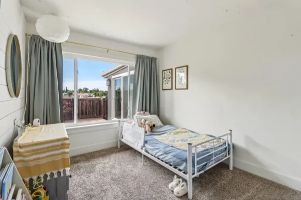 a living room with a bed furniture and a large window