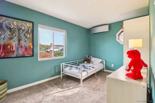 a bedroom with a bed and window