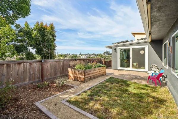 a view of a backyard with sitting area