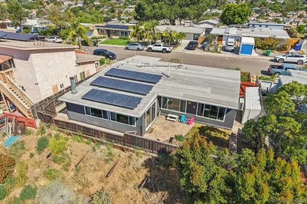 an aerial view of a house with swimming pool and sitting area