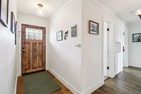 a view of an entryway with wooden floor