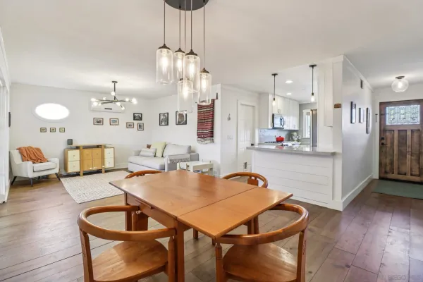 a living room with kitchen island furniture and wooden floor