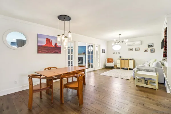 a view of a dining room with furniture wooden floor and chandelier