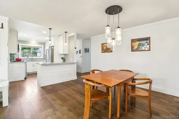 a living room with kitchen island furniture and a chandelier