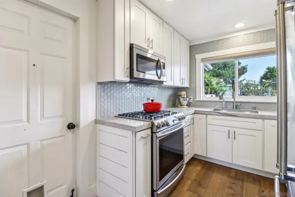 a kitchen with stainless steel appliances granite countertop a stove and a sink