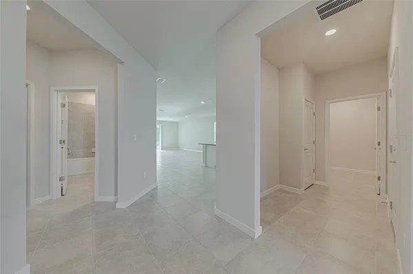 an empty room with a empty space and windows