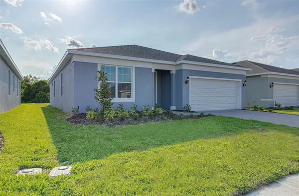 a front view of house with yard and green space
