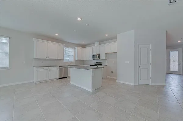 a kitchen with white cabinets and white appliances