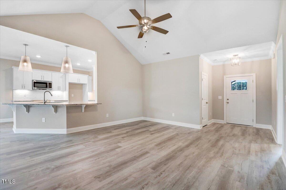 9550 Bear Run Lane Middlesex, NC 27557 - Photo 12 of 32 an empty room with wooden floor and windows