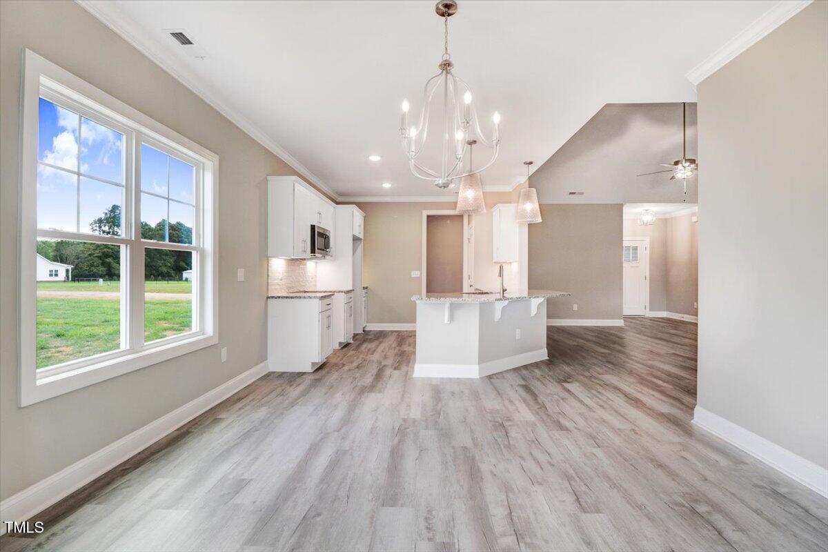 9550 Bear Run Lane Middlesex, NC 27557 - Photo 15 of 32 a view of a big room with wooden floor and windows