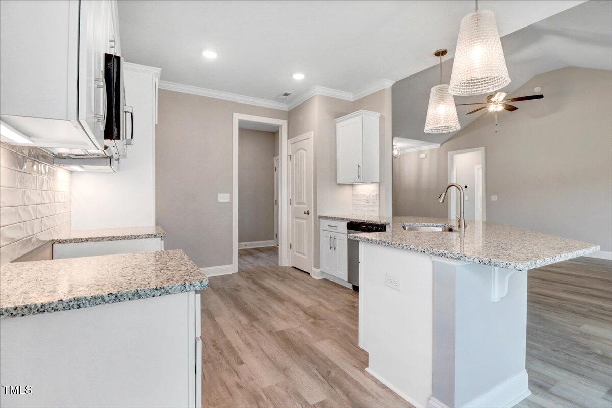 9550 Bear Run Lane Middlesex, NC 27557 - Photo 16 of 32 a kitchen with stainless steel appliances granite countertop a sink and a refrigerator