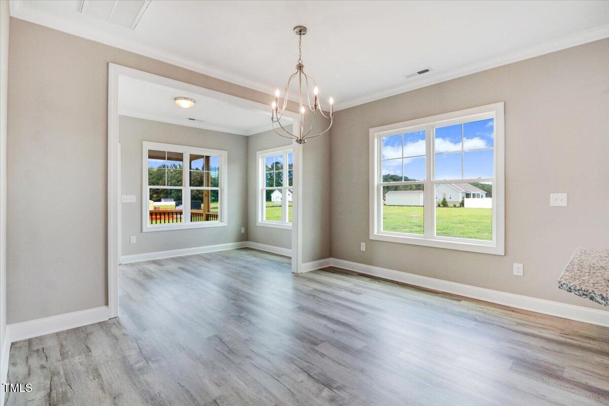 9550 Bear Run Lane Middlesex, NC 27557 - Photo 19 of 32 a view of an empty room with wooden floor and a window