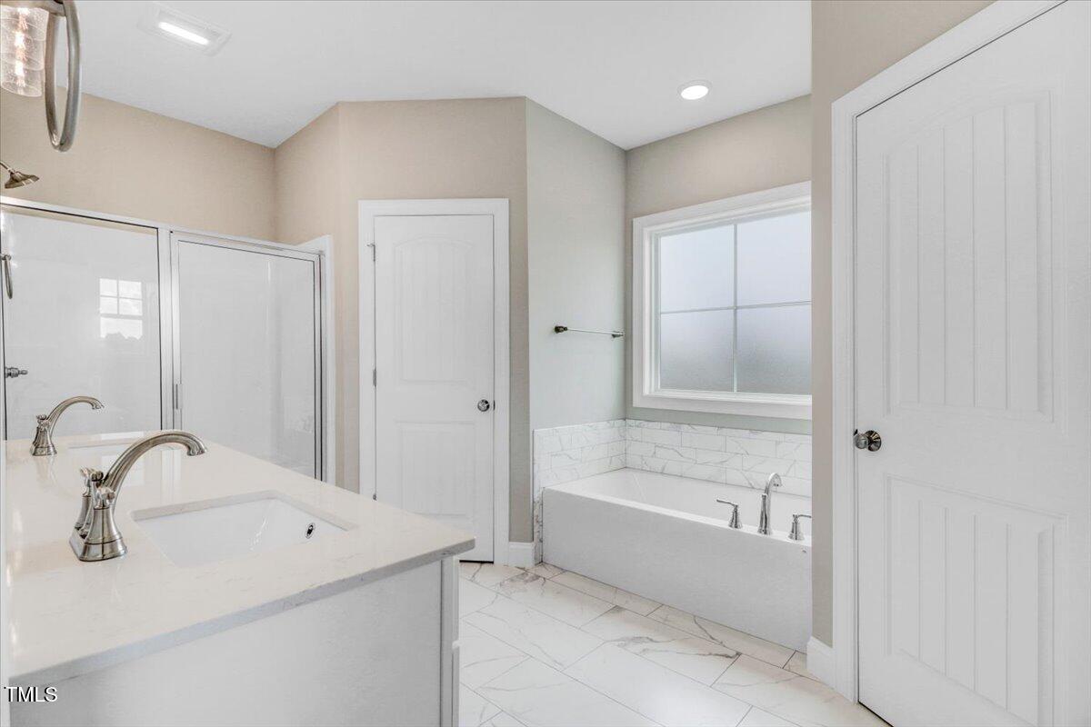 9550 Bear Run Lane Middlesex, NC 27557 - Photo 23 of 32 a bathroom with a bathtub and a sink