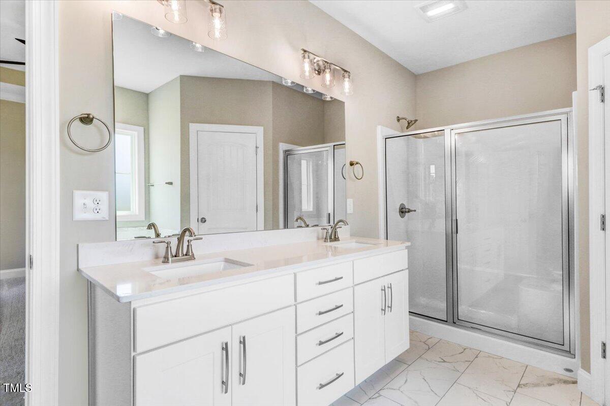 9550 Bear Run Lane Middlesex, NC 27557 - Photo 24 of 32 a bathroom with a double vanity sink mirror and shower