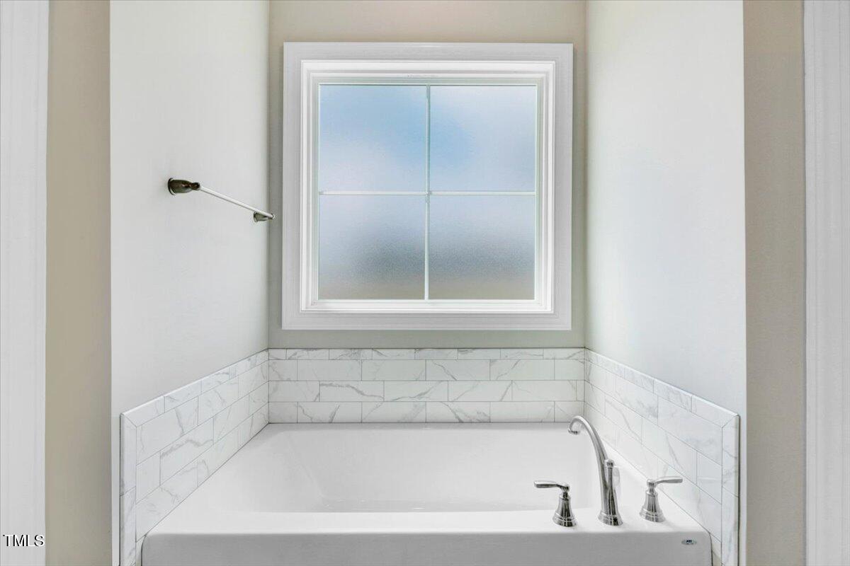 9550 Bear Run Lane Middlesex, NC 27557 - Photo 25 of 32 a white bath tub sitting next to a window
