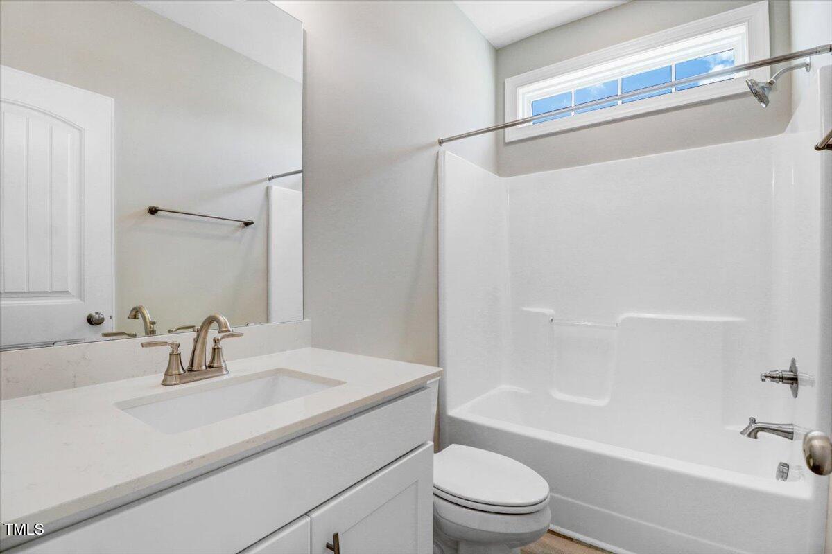 9550 Bear Run Lane Middlesex, NC 27557 - Photo 28 of 32 a bathroom with a sink a mirror and a shower