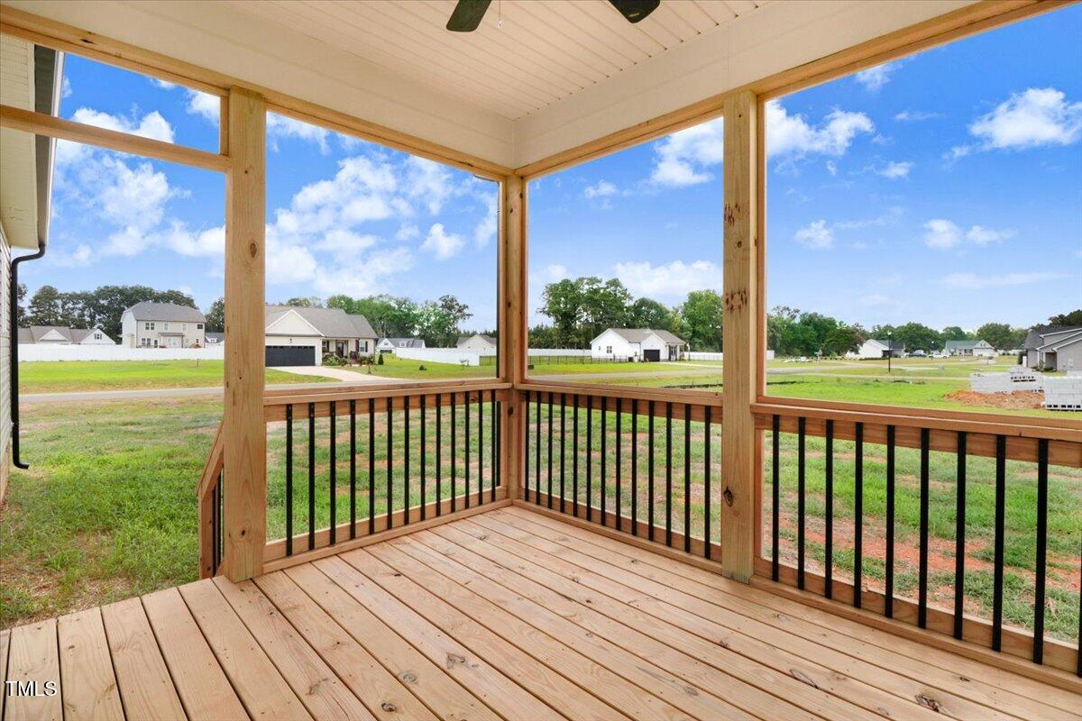 9550 Bear Run Lane Middlesex, NC 27557 - Photo 8 of 32 a view of a wooden balcony with a yard