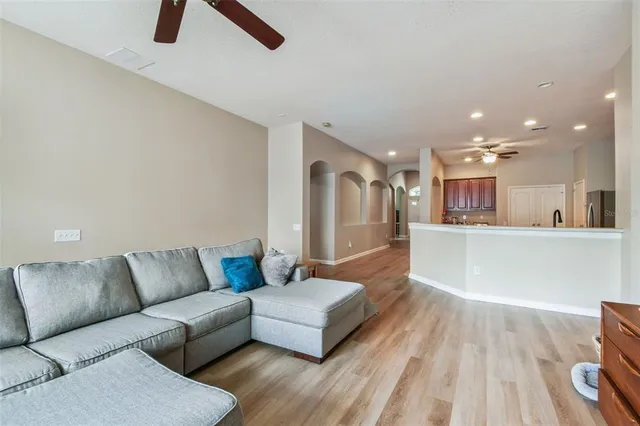 a living room with furniture and kitchen view