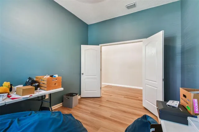 a bedroom with a bed and a workspace