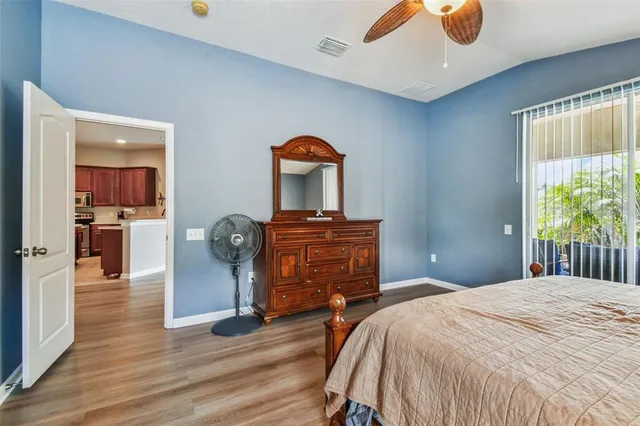 a bedroom with a bed and wooden floor