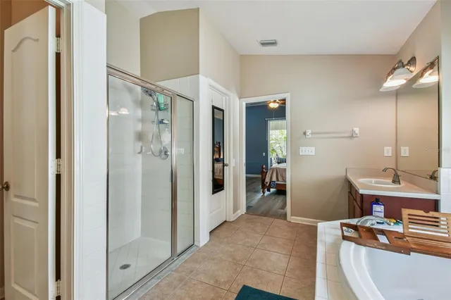 a bathroom with a sink mirror toilet and shower