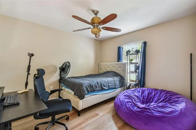 a bedroom with furniture and wooden floor