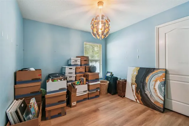 a bedroom with furniture and a chandelier