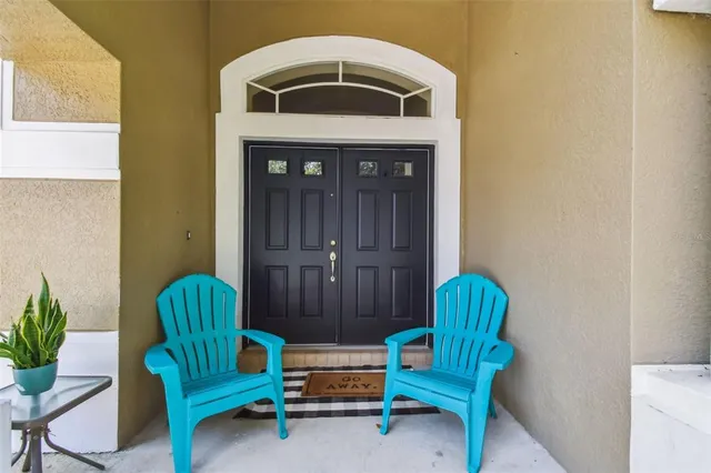a living room with furniture and a chair