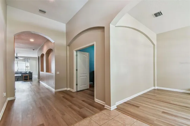 a view of a hallway with wooden floor