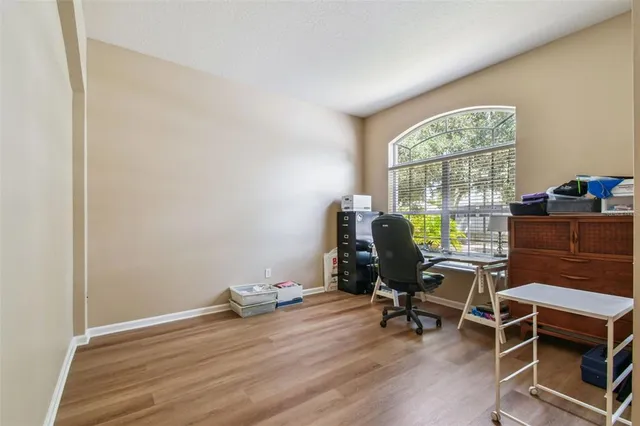 a view of a workspace with furniture and a window