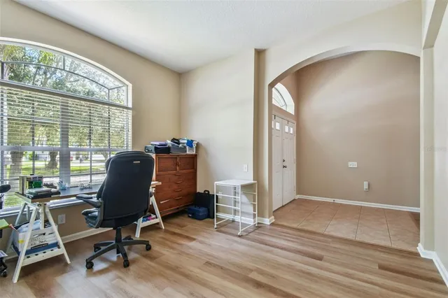 a view of a workspace with furniture and a window