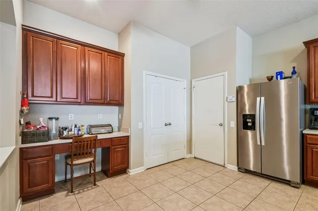 a kitchen with stainless steel appliances a refrigerator and cabinets
