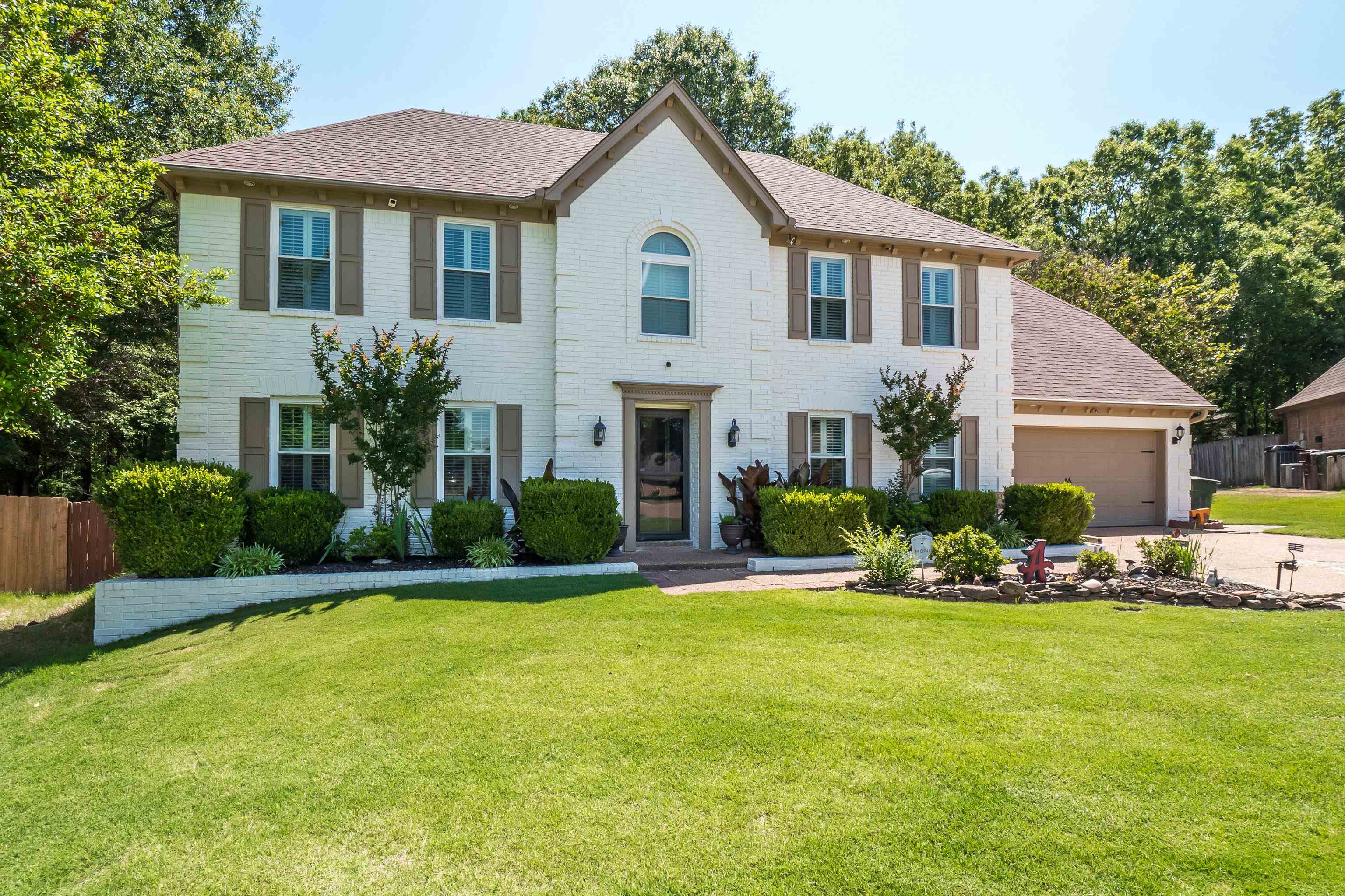 226 Wolf Ridge Cove Collierville, TN 38017 - Photo 1 of 25 a front view of a house with a yard and porch