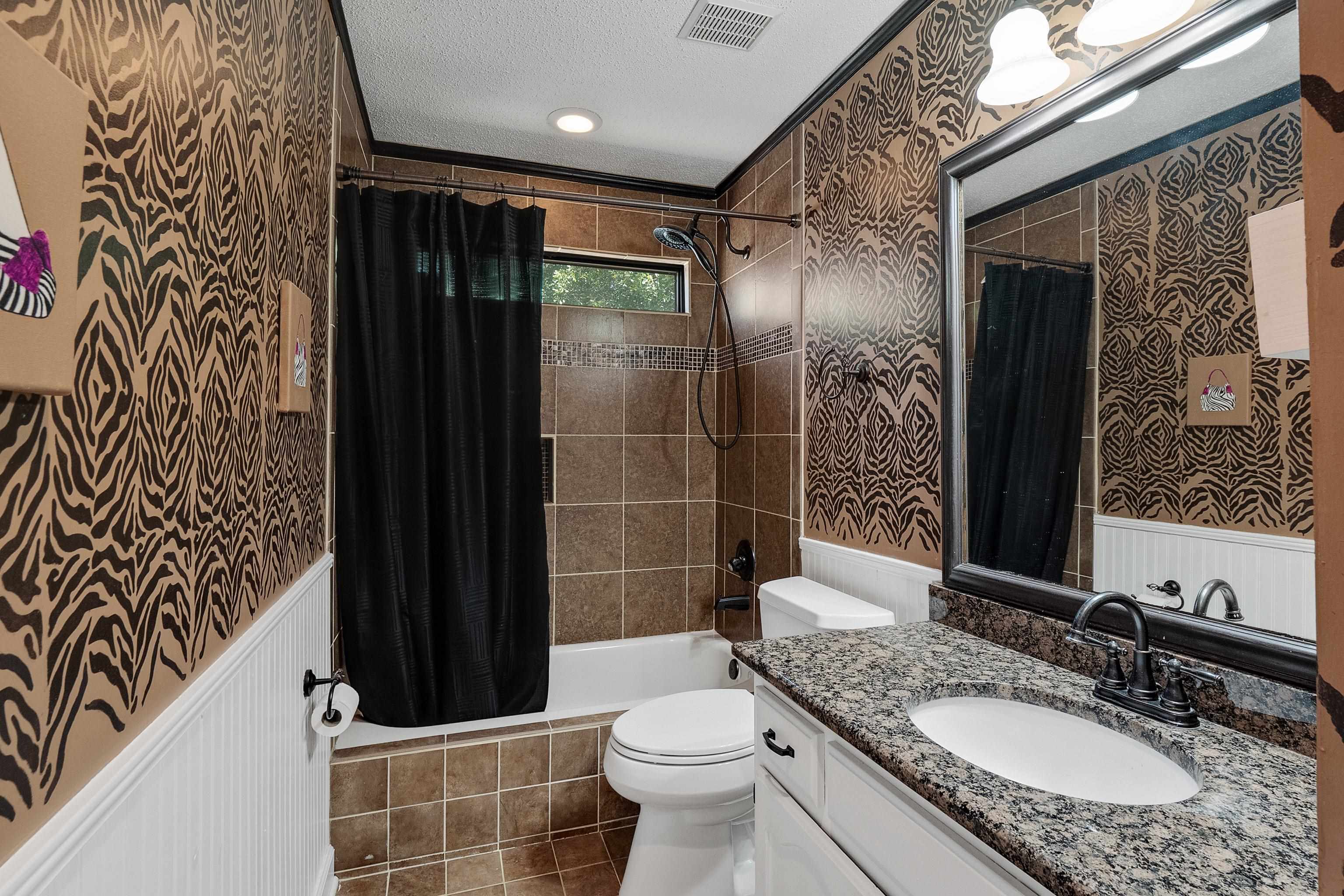 226 Wolf Ridge Cove Collierville, TN 38017 - Photo 15 of 25 a bathroom with a granite countertop sink toilet a mirror and shower