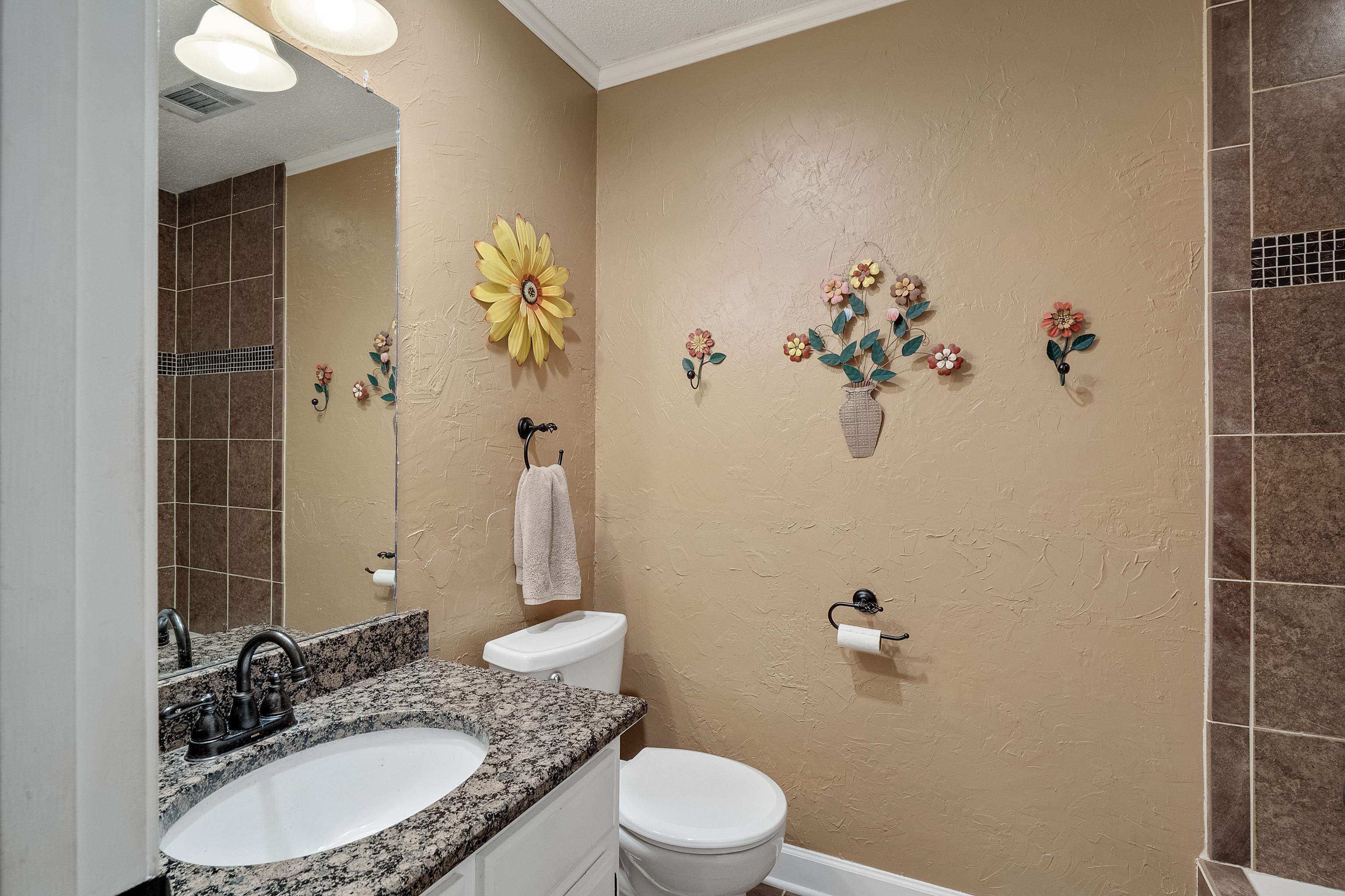 226 Wolf Ridge Cove Collierville, TN 38017 - Photo 18 of 25 a bathroom with a granite countertop sink a toilet and shower