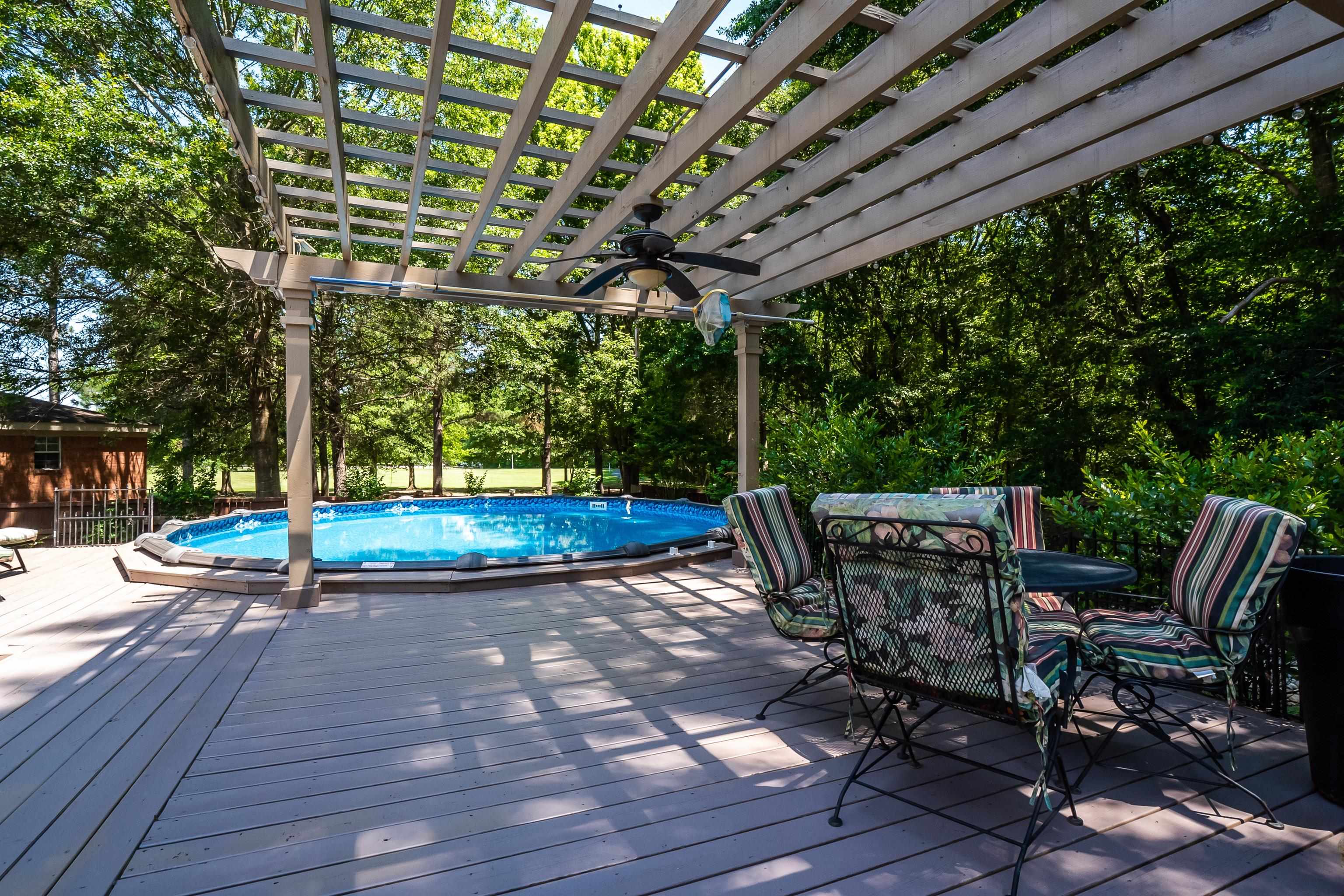 226 Wolf Ridge Cove Collierville, TN 38017 - Photo 22 of 25 a view of patio with table and chairs a barbeque with wooden floor and fence