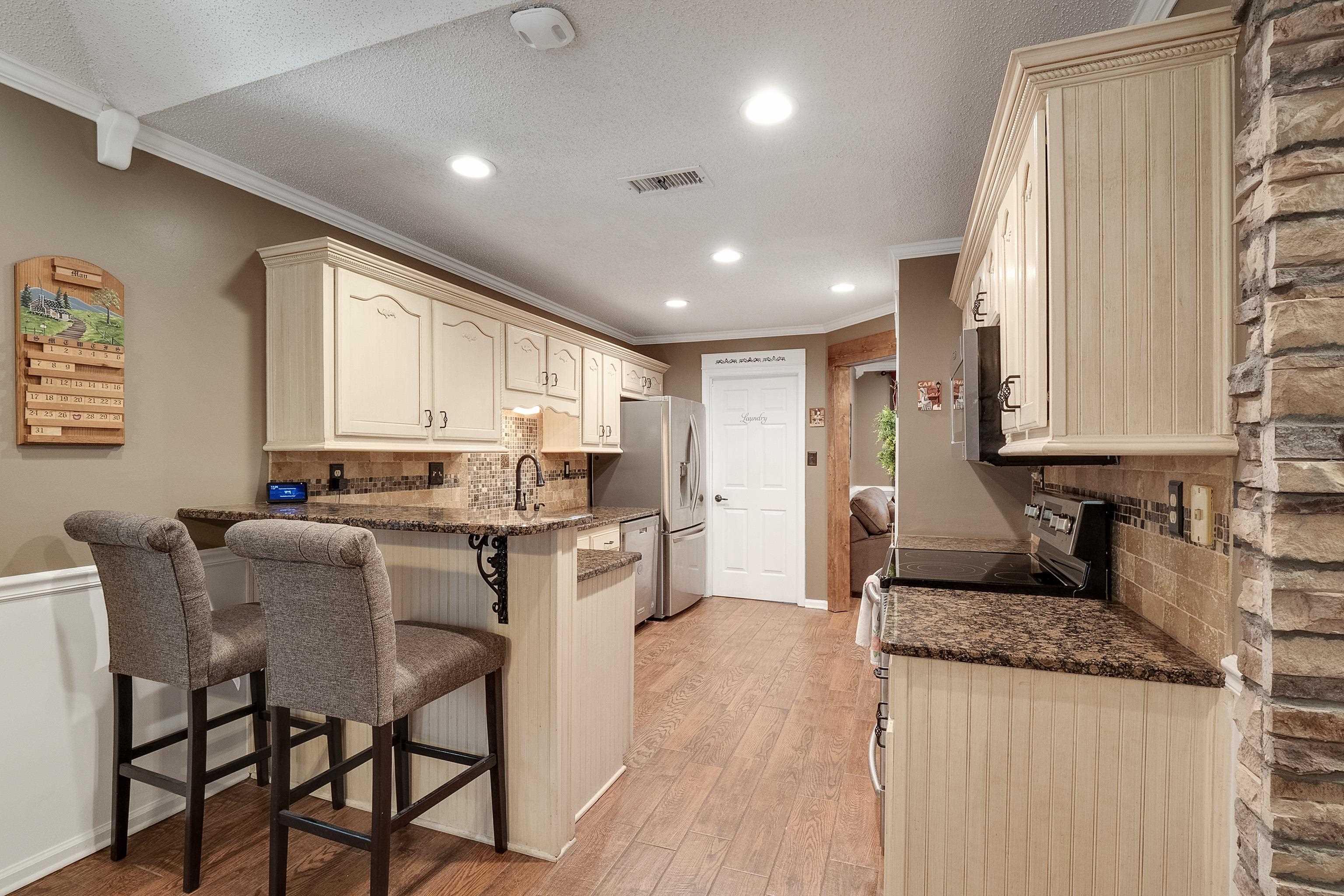 226 Wolf Ridge Cove Collierville, TN 38017 - Photo 6 of 25 a kitchen with granite countertop sink cabinets and stainless steel appliances