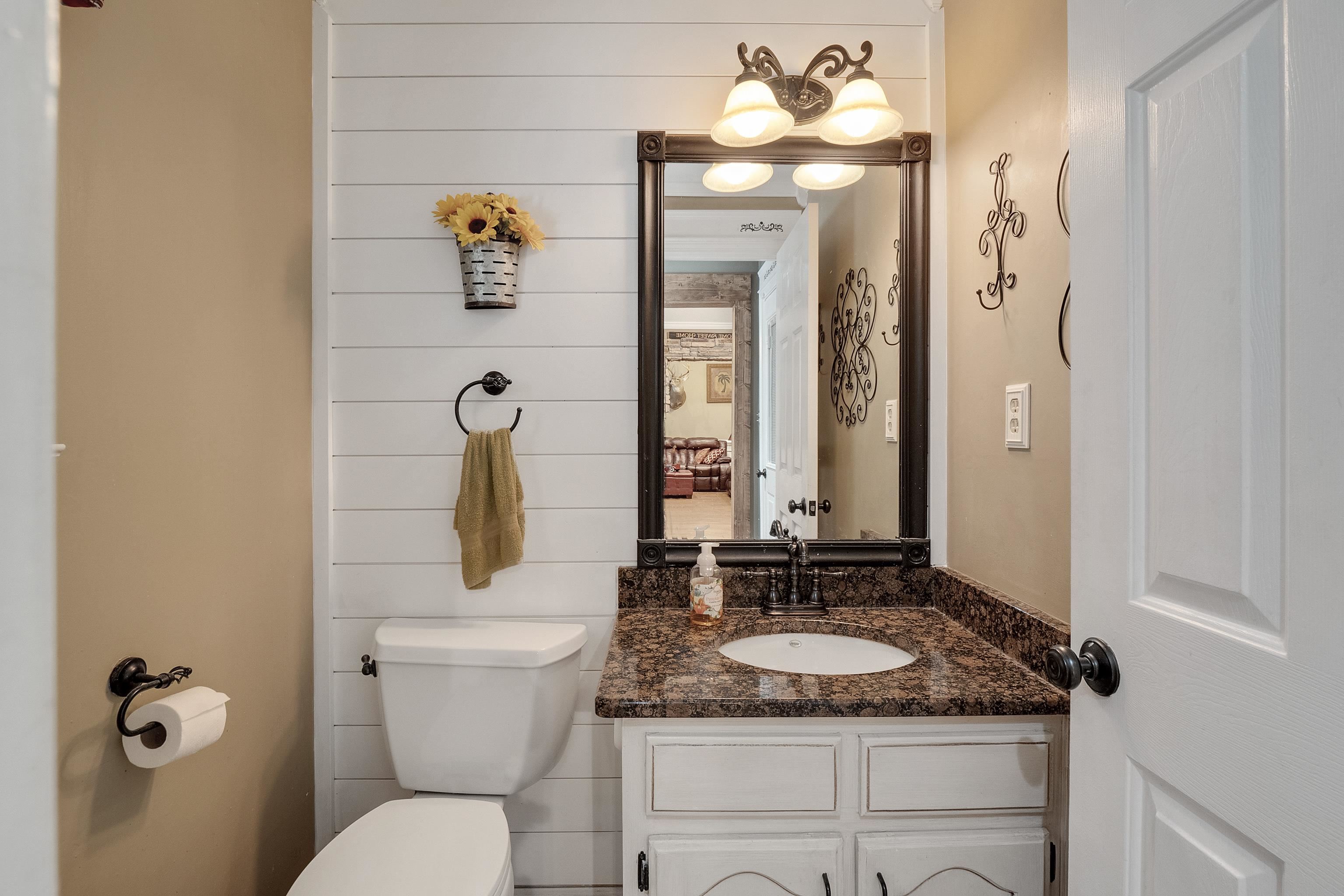 226 Wolf Ridge Cove Collierville, TN 38017 - Photo 8 of 25 a bathroom with a granite countertop sink and a mirror