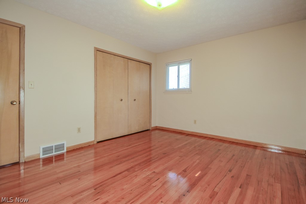 30224 Regent Road Wickliffe, OH 44092 - Photo 13 of 27 Unfurnished bedroom with light wood-type flooring and a closet