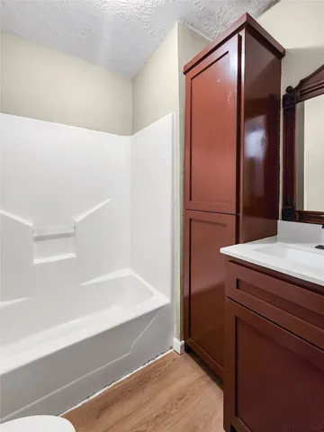 a bathroom with a bathtub and a shower