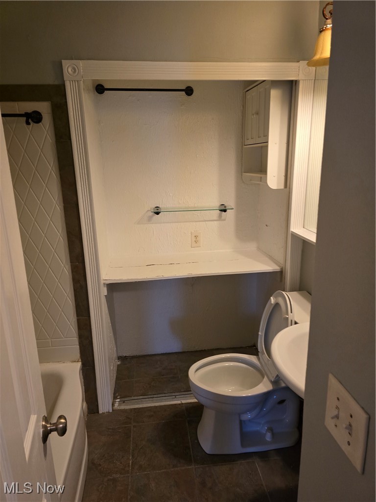 21212 Watson Road Maple Heights, OH 44137 - Photo 17 of 24 Bathroom with tile patterned floors, sink, toilet, and a tub to relax in