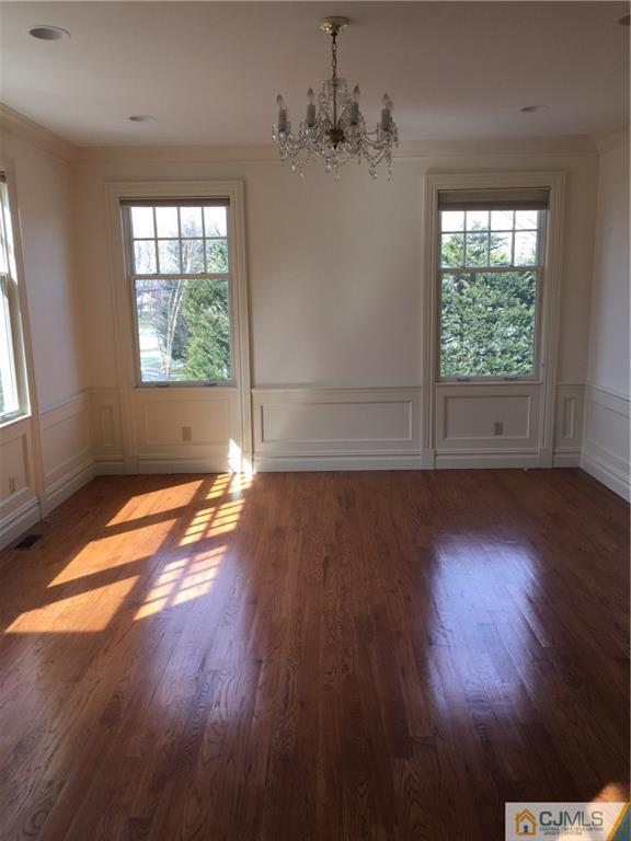 69 Athens Road Short Hills, NJ 07078 - Photo 12 of 25 an empty room with wooden floor and windows