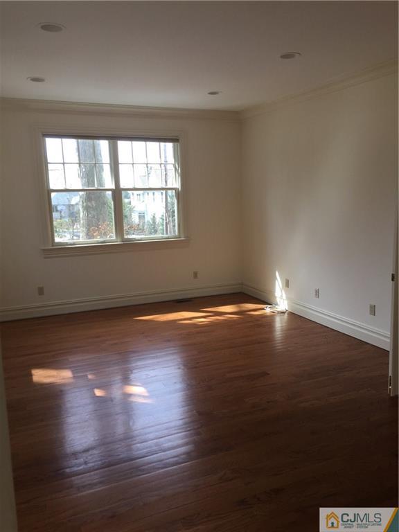 69 Athens Road Short Hills, NJ 07078 - Photo 15 of 25 an empty room with wooden floor and windows