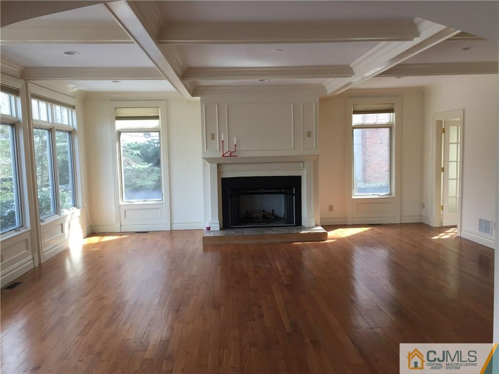 69 Athens Road Short Hills, NJ 07078 - Photo 16 of 25 a view of an empty room with wooden floor and a window