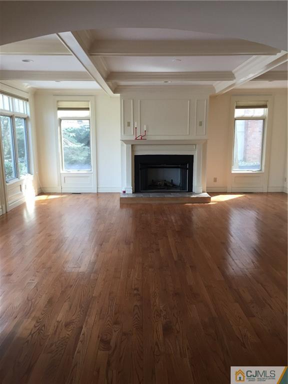 69 Athens Road Short Hills, NJ 07078 - Photo 17 of 25 a view of an empty room with wooden floor fireplace and a window