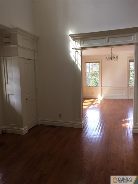 69 Athens Road Short Hills, NJ 07078 - Photo 18 of 25 an empty room with wooden floor and windows