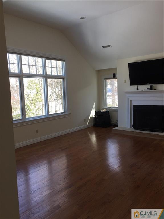 69 Athens Road Short Hills, NJ 07078 - Photo 19 of 25 a living room with a flat screen tv and a fireplace
