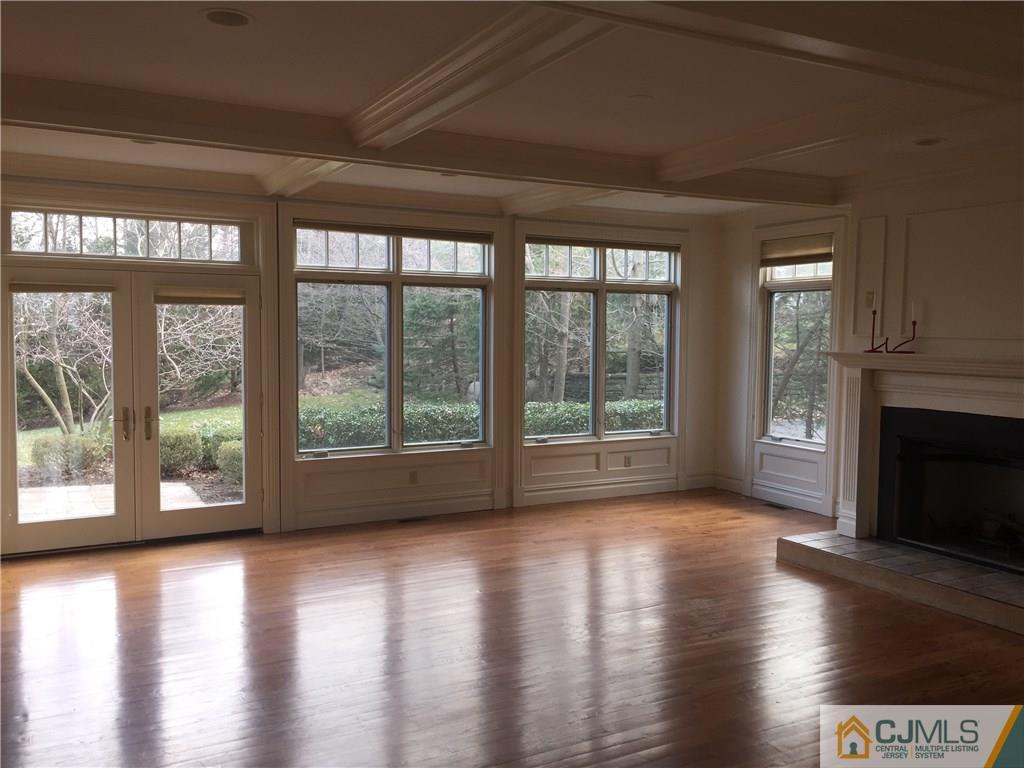 69 Athens Road Short Hills, NJ 07078 - Photo 3 of 25 a view of a room with wooden floor and a fireplace