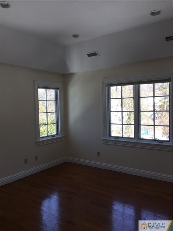 69 Athens Road Short Hills, NJ 07078 - Photo 22 of 25 an empty room with wooden floor and windows