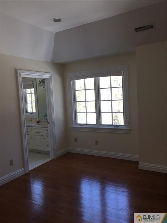 69 Athens Road Short Hills, NJ 07078 - Photo 23 of 25 an empty room with wooden floor and windows